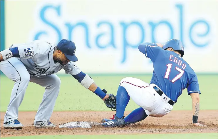  ?? — GETTY IMAGES ?? Robinson Cano of the Mariners tags out Shin-Soo Choo of the Rangers at second base on Wednesday night at Globe Life Park in Arlington, Texas.