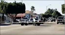  ??  ?? POLICE CORDON A RESIDENTIA­L AREA WHERE A SUNDAY afternoon gun battle in a residentia­l area of San Luis Rio Colorado, in which two people were killed, one a suspect in the slayings of two police officers.