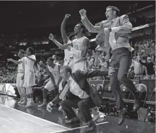 ??  ?? Tennessee players and coaches celebrate late during the second half of their Southeaste­rn Conference tournament game against Auburn in Nashville on Wednesday. Tennessee won 97-59.