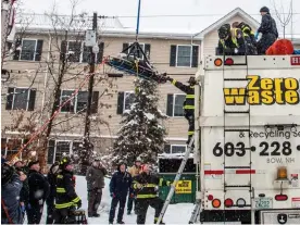  ?? Photograph: Jeffrey Hastings ?? Firefighte­rs rescue the woman from the garbage truck in Manchester, New Hampshire, on Monday.