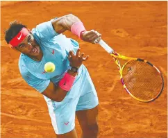  ?? ANNE- CHRISTINE POUJOULAT / AFP VIA GETTY IMAGES ?? Spain’s Rafael Nadal serves to Italy’s Jannik Sinner during their men’s singles quarter-final match earlier this
week at the French Open in Paris.