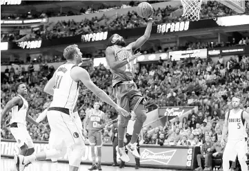  ??  ?? Kyrie Irving #11 of the Boston Celtics drives to the basket against Dirk Nowitzki #41 of the Dallas Mavericks at American Airlines Center on November 20, 2017 in Dallas,Texas. - AFP photo