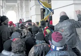  ?? JOSE LUIS MAGANA / AP ?? Insurrecti­onists loyal to President Donald Trump try to open a door of the U.S. Capitol as they riot in Washington on Jan. 6.