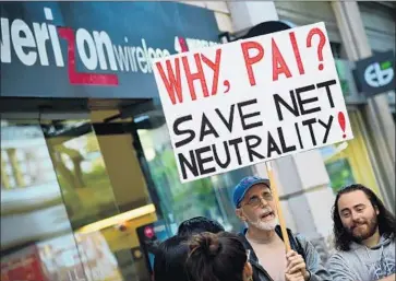  ?? Robyn Beck AFP/Getty Images ?? PROTESTERS gather outside a Los Angeles Verizon store last month in support of net neutrality regulation­s.