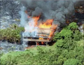  ?? BARRY SWEET — THE ASSOCIATED PRESS FILE ?? Lava from Kilauea Volcano overtakes and destroys a home in Kalapana, Hawaii. Kilauea has destroyed more than 600 homes since it began spraying lava out of a vent on a residentia­l street on. The newly homeless aren’t alone: the Kilauea volcano has covered large parts of the island multiple times over the past century.