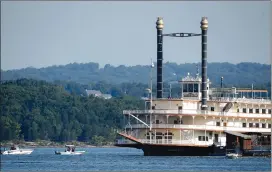  ?? Associated Press photo ?? Emergency workers patrol an area Friday near where a duck boat capsized the night before resulting in at least 13 deaths on Table Rock Lake in Branson, Mo.