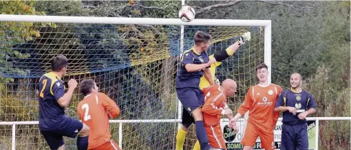  ??  ?? Llandudno Junction (blue) on the attack against Barmouth during last weekend’s Trophy battle. Picture: STEVE LEWIS