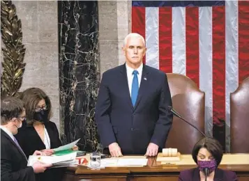  ?? J. SCOTT APPLEWHITE AP FILE ?? Vice President Mike Pence returns to the House chamber to finish presiding over the Electoral College certificat­ion in the early hours of Jan. 7, 2021, after a mob loyal to President Donald Trump disrupted the process.