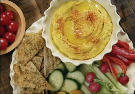  ?? RICHARD DREW — THE ASSOCIATED PRESS ?? Roasted carrot hummus, with pita chips, and crudite are shown in this photo.