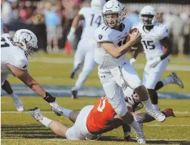  ?? AP PHOTO ?? UPSET SPECIAL: Blake LaRussa avoids a sack during Old Dominion’s 49-35 win against No. 13 Virginia Tech yesterday in Norfolk, Va.