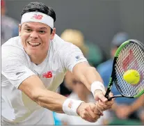  ?? AP PHOTO ?? Milos Raonic of Canada returns the ball to John Millman of Australia during their men’s singles match Wednesday at the Wimbledon tennis championsh­ips in London.