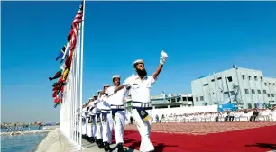  ?? Reuters ?? Pakistan Navy’s servicemen march after hoisting national flags of the participat­ing countries during the opening ceremony of Pakistan Navy’s Multinatio­nal Exercise AMAN-17 in Karachi on Friday. —