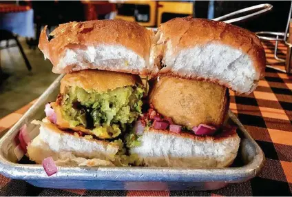  ?? Alison Cook / Staff ?? Vada Pav at Nirmanz Food Boutique in Sugar Land: spicy, herbal potato cutlets with chutney and red onion on butter-grilled rolls.