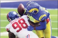  ?? Harry How / Getty Images ?? Austin Johnson (98) of the New York Giants hits Gerald Everett (81) of the Los Angeles Rams causing a fumble during the first half at SoFi Stadium on Oct. 4 in Inglewood, Calif. Johnson re-signed with the Giants.