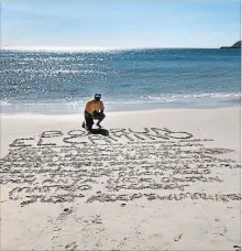  ?? FACEBOOK ?? In the sand on a beach at the end of his Box Run El Camino, Mike Strange wrote the names of all the children he ran for.