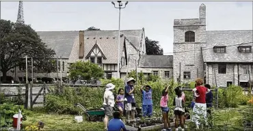  ?? PHOTOS BY KATIE RAUSCH/(TOLEDO) BLADE ?? Marilyn DuFour (center), who helps to lead garden efforts atMonroe Street United Methodist Church in Toledo, tells students howto plant seeds at the church’s community garden.