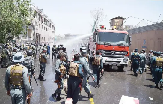  ??  ?? Afghan security forces use water canons to disperse protesters during Friday’s clashes in Kabul. (AFP)