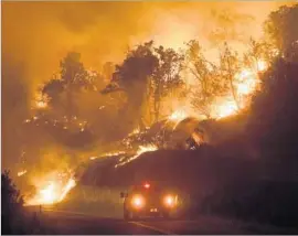  ?? Noah Berger European Pressphoto Agency ?? THE DETWILER fire spreads down a hillside Monday near Mariposa, Calif. As of 6 p.m. Monday, the 11,200-acre blaze was only 5% contained, officials said.