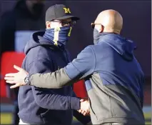  ?? CARLOS OSORIO — THE ASSOCIATED PRESS ?? Michigan head coach Jim Harbaugh, left, greets Penn State head coach James Franklin after Saturday’s game in Ann Arbor. Penn State won 27-17.
