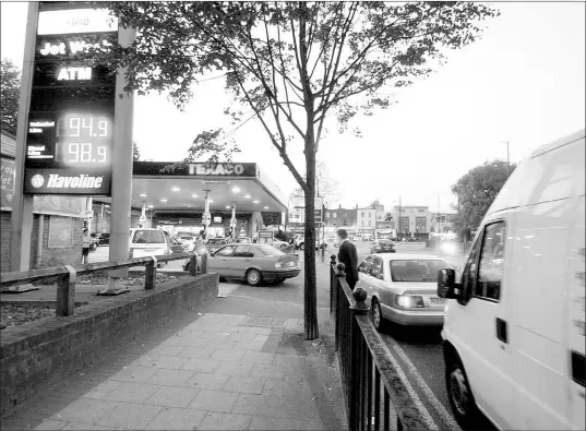  ??  ?? Motorists queue for fuel outside a Texaco garage in Poplar, east London, last night. Some fi lling stations ran out of petrol and motorists queued to fi nd there was only diesel available at the pumps