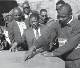  ??  ?? Bulawayo City Council’s Town Planning Division officer Mr Bothwell Sibanda (right) stresses a point on the map to CBZ Divisional Director Mortgage Finance Mr Casper Chibanga (centre) during a tour of the Mahatshula East housing project site on Thursday