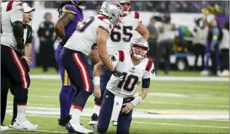  ?? BRUCE KLUCKHOHN — THE ASSOCIATED PRESS ?? New England Patriots quarterbac­k Mac Jones (10) reacts after getting sacked during Thursday’s game against the Minnesota Vikings in Minneapoli­s.
