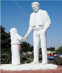  ?? Associated Press ?? A statue in tribute to Father Stanley Rother stands Thursday on the grounds of Holy Trinity Catholic Church in Okarche, Okla.