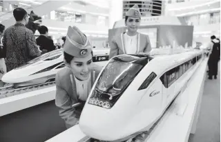  ??  ?? This file photo taken on August 13, 2015 shows Indonesian models looking at scale models of Chinese-made bullet trains on exhibition at a shopping mall in Jakarta. AFP PHOTO SAN FRANCISCO: