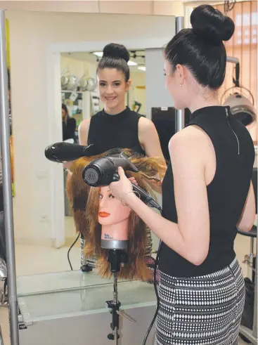  ??  ?? CHECK IT OUT: TAFE North Queensland hairdressi­ng student Eva Condullas encourages residents to attend the institute’s upcoming informatio­n sessions for next year’s courses.