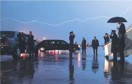  ?? Picture: AFP ?? Donald Trump disembarks from Air Force One as lightning splits the sky during a storm at Andrews Air Force Base near Washington.