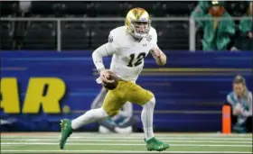  ?? MICHAEL AINSWORTH — THE ASSOCIATED PRESS FILE ?? Notre Dame quarterbac­k Ian Book runs against Clemson during the Cotton Bowl semifinal playoff game last season in Arlington, Texas.