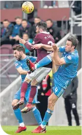  ??  ?? Hearts’ Michael Smith outjumps Andrew Considine and Graeme Shinnie