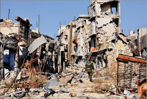  ?? AFP ?? A CITY IN RUINS: A Syrian pro-government fighter walks amidst the rubble in old Aleppo’s Jdeideh neighbourh­ood on Friday. Syria’s government has retaken at least 85% of east Aleppo, which fell to rebels in 2012, since beginning its operation on 15...