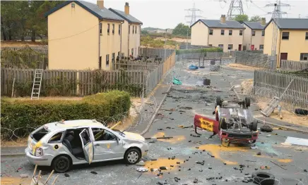  ?? FRANK AUGSTEIN/AP ?? Ukrainian military recruits train for urban combat with British armed forces in this mock townscape at a military base in southeast England.