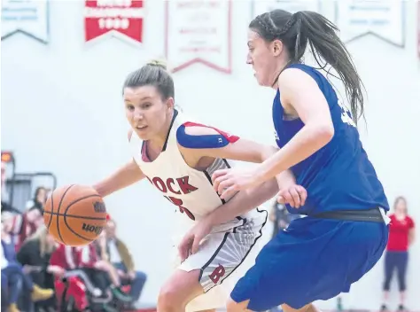  ?? JULIE JOCSAK/STANDARD STAFF ?? Baelie Campbell of the Brock Badgers runs the ball past Bridget O'Reilly of the Lakehead Thunderwol­ves in varsity basketball action at Brock University in St. Catharines on Wednesday.