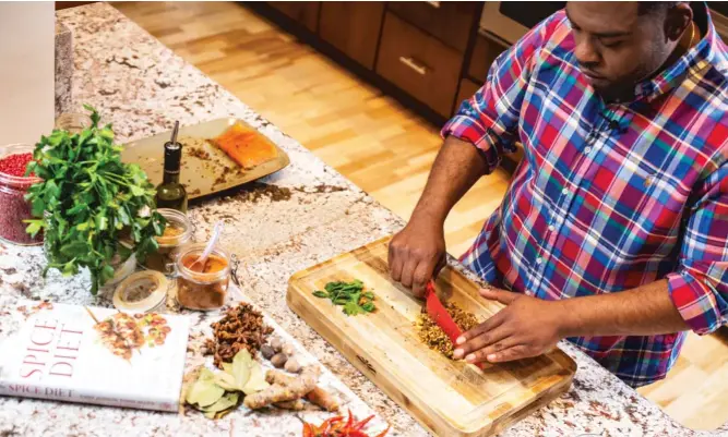  ??  ?? Judson Todd Allen makes New Orleans Pecan Crusted Salmon, a recipe from his new book, “The Spice Diet: Use Powerhouse Flavor to Fight Cravings and Win theWeight- Loss Battle.”