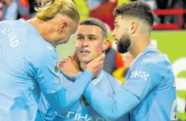  ?? AP ?? Manchester City’s Phil Foden (centre) celebrates with teammates Erling Haaland (left) and Josko Gvardiol after scoring his side’s third goal during the English Premier League match between Brentford and Manchester City at the Gtech Community Stadium in London yesterday.