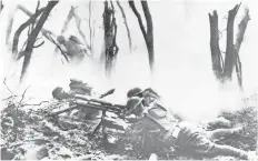  ?? AP FILE PHOTO ?? Below, U. S. soldiers man their weapon during an Allied offensive Sept. 26, 1918, in France. The American presence in World War I helped tip the balance of the conflict against the Germans.