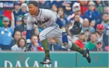  ?? THE ASSOCIATED PRESS ?? Braves rookie Ronald Acuna Jr. begins to slide as he scores on a tworun double by Freddie Freeman in the fifth inning Sunday against the Boston Red Sox.