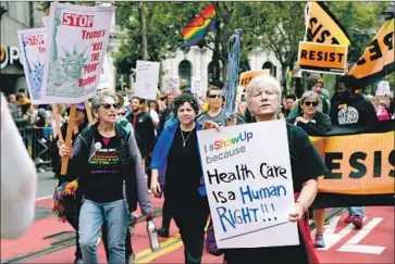  ?? Meera Fox Getty Images ?? HEALTHCARE activists march in the 2017 Gay Pride parade in San Francisco, where Dignity Health is based.