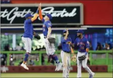  ?? JOE SKIPPER — THE ASSOCIATED PRESS ?? From left to right, New York Mets’ Jose Reyes, Brandon Nimmo, Amed Rosario and Austin Jackson celebrate after their win over the Miami Marlins in a baseball game in Miami, Sunday.