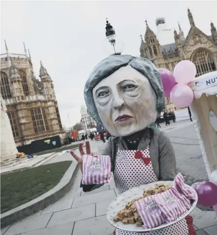  ?? PICTURE: DAN KITWOOD/GETTY ?? 0 A protester dressed as a caricature of Theresa May hands out ‘May’s Brexit Fudge’