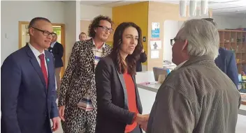  ??  ?? Dr David Clark, far left, and Prime Minister Jacinda Ardern meet a cancer patient at Auckland Hospital.