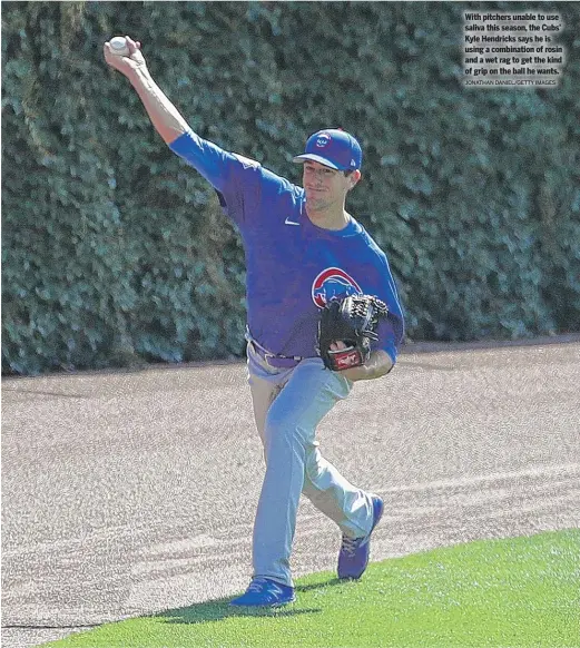  ?? JONATHAN DANIEL/GETTY IMAGES ?? With pitchers unable to use saliva this season, the Cubs’ Kyle Hendricks says he is using a combinatio­n of rosin and a wet rag to get the kind of grip on the ball he wants.