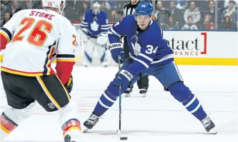  ?? CLAUS ANDERSEN/GETTY IMAGES ?? Toronto Maple Leafs’ centre Auston Matthews skates with the puck against the Calgary Flames during an NHL game at the Air Canada Centre, on Dec. 6, in Toronto. The Leafs defeated the Flames 2-1 in a shootout.
