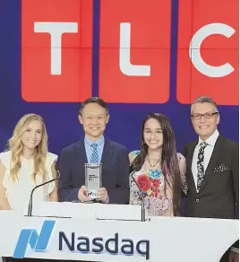  ?? PHOTO COURTESY OF JEFF GULKO ?? Boston-born musician Jessie Chris, with TLC President Howard Lee and network stars Jazz Jennings and Randy Fenoli, ringing the NASDAQ bell in celebratio­n of the Give a Little TLC Awards.