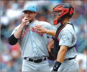  ??  ?? San Francisco Giants relief pitcher Bryan Morris is patted by catcher Nick Hundley as he waits to be pulled from the mound after giving up an RBI double in the seventh inning of Saturday’s 5-1 loss to the Colorado Rockies in Denver.
CINCINNATI (AP) –...