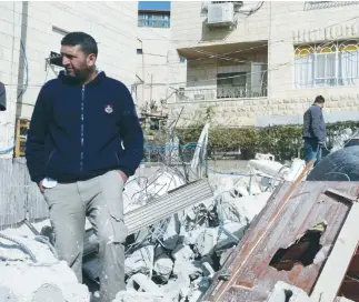  ?? (Hussam Abed/B’Tselem) ?? A MAN walks through the rubble of the Beit Hanina home demolished yesterday on orders of the government.