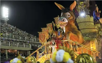  ?? SILVIA IZQUIERDO — THE ASSOCIATED PRESS ?? Performers from the Sao Clemente samba school parade on a float during Carnival celebratio­ns at the Sambadrome in Rio de Janeiro, Brazil.