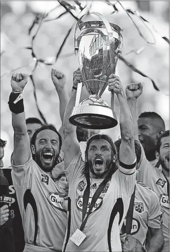  ?? [KYLE ROBERTSON/DISPATCH PHOTOS] ?? Frankie Hejduk holds up the MLS Cup after the Crew won its only league title in 2008.